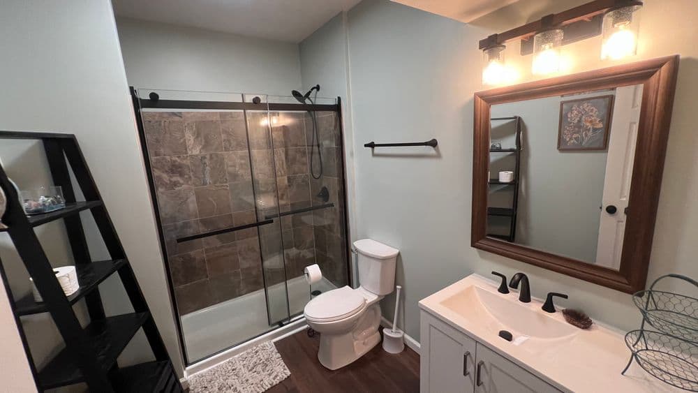 Modern bathroom featuring shower, vanity, and stylish decor in neutral tones.